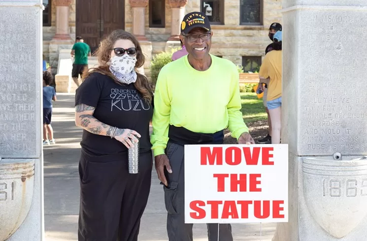 Activists Jessica Luther Rummel and Willie Hudspeth stand under Denton's Confederate statue Tuesday morning ahead of the county commissioners' meeting.